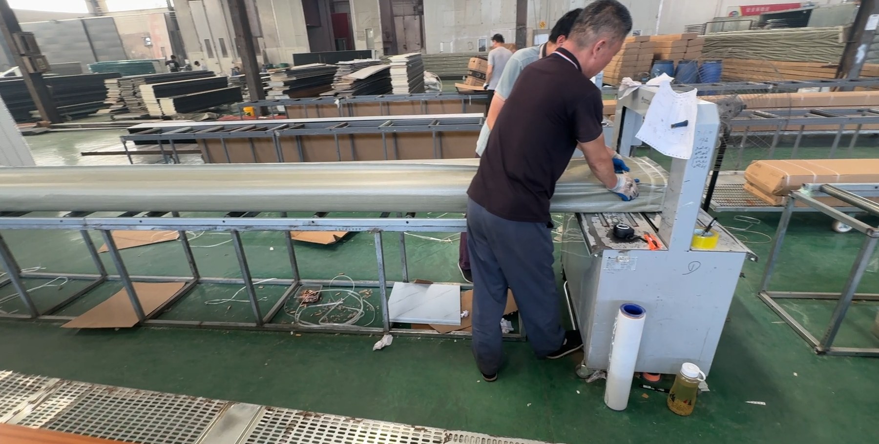 Factory worker handling and packing finished wall panels
